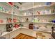 Well-stocked walk-in pantry featuring custom shelving for organized storage at 3076 East Lake Rd, Mcdonough, GA 30252