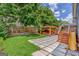 Landscaped backyard featuring a pergola and elevated deck with slide at 496 Rankin Ne St, Atlanta, GA 30308