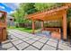 Inviting backyard featuring a wooden pergola with built-in seating and a stone patio at 496 Rankin Ne St, Atlanta, GA 30308