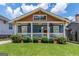 Charming home featuring a cozy porch and well-manicured front yard with lush green lawn at 496 Rankin Ne St, Atlanta, GA 30308