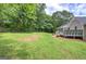 Large, level backyard with lush green grass and mature trees, perfect for outdoor activities and relaxation at 400 Kenny Ln, Temple, GA 30179