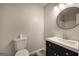 Bathroom with a modern vanity, stylish mirror, and a toilet, all with neutral-colored walls at 400 Kenny Ln, Temple, GA 30179