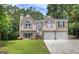 Inviting two-story home with a well-manicured lawn, two car garage, and charming architectural details at 400 Kenny Ln, Temple, GA 30179