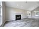 Bright living room with vaulted ceiling, fireplace, and large windows providing ample natural light at 400 Kenny Ln, Temple, GA 30179