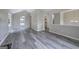 Open-concept living room with modern flooring, ample natural light, and seamless flow to kitchen at 400 Kenny Ln, Temple, GA 30179