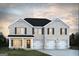 Charming two-story home featuring a brick facade, complemented by dark shutters and a spacious three-car garage at 1662 Fuma Leaf Way # 308, Mcdonough, GA 30253