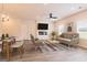 Inviting living room bathed in natural light, featuring sleek furniture, and seamlessly flowing into the dining area at 1662 Fuma Leaf Way # 308, Mcdonough, GA 30253