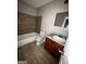 Bathroom featuring tiled walls and floors, a bath, a sink with vanity, and a toilet at 11313 Michelle Way, Hampton, GA 30228