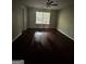 A bright bedroom with refinished dark wood floors and a ceiling fan at 11313 Michelle Way, Hampton, GA 30228