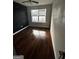 Bedroom with hardwood floors, ceiling fan, and a large window offering natural light at 11313 Michelle Way, Hampton, GA 30228