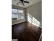 Cozy bedroom featuring beautiful wood floors and plenty of natural light from a large window at 11313 Michelle Way, Hampton, GA 30228