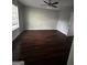 Spacious bedroom with hardwood floors, a ceiling fan, and natural light coming through a window at 11313 Michelle Way, Hampton, GA 30228