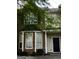 Traditional-style home with red brick and beige siding, black front door, and professionally monitored security system at 11313 Michelle Way, Hampton, GA 30228