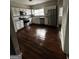 Bright kitchen featuring stainless steel appliances, white cabinets, granite countertops, and hardwood floors at 11313 Michelle Way, Hampton, GA 30228