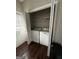 Laundry room featuring modern washer and dryer with white walls and hardwood floors at 11313 Michelle Way, Hampton, GA 30228