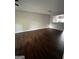 Open-concept living room boasts gleaming hardwood floors and a view of the bright, modern kitchen at 11313 Michelle Way, Hampton, GA 30228