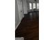 Living room featuring shiny dark hardwood flooring, a ceiling fan, and bright natural light from multi-pane windows at 11313 Michelle Way, Hampton, GA 30228