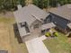 Aerial view showcasing the home's roof, driveway, landscaping, and proximity to neighboring houses at 1001 Hartwell Rd, Locust Grove, GA 30248
