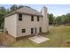 Two-story home with brick foundation features green lawn, concrete patio, and neutral siding on a sunny day at 1001 Hartwell Rd, Locust Grove, GA 30248