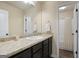 Bathroom featuring a vanity with dark cabinets and a mirror, plus a shower-tub combination at 1001 Hartwell Rd, Locust Grove, GA 30248