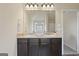 Modern bathroom featuring granite counter with double sinks and dark wood cabinets at 1001 Hartwell Rd, Locust Grove, GA 30248