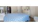 Carpeted bedroom showcases light blue blanket-covered bed, a dresser, and a closet with clothes hanging in view at 1001 Hartwell Rd, Locust Grove, GA 30248
