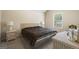 Cozy bedroom with carpet floors and a bed with a patterned blanket at 1001 Hartwell Rd, Locust Grove, GA 30248