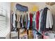 Walk-in closet with metal shelving filled with clothes, boxes, and shoes at 1001 Hartwell Rd, Locust Grove, GA 30248