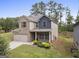 Two-story home with brick and siding, gray shutters, a two-car garage, and a well-maintained yard at 1001 Hartwell Rd, Locust Grove, GA 30248