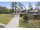 Two-story home featuring a neutral color scheme, a two-car garage, and green front lawn at 1001 Hartwell Rd, Locust Grove, GA 30248