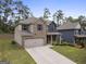 Two-story home with brick and siding, gray shutters, a two-car garage, and a well-maintained yard at 1001 Hartwell Rd, Locust Grove, GA 30248