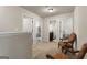 Open carpeted hallway with 2 chairs and access to bedroom and bath in a home ready for move-in at 1001 Hartwell Rd, Locust Grove, GA 30248