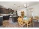 Open-concept kitchen with dark cabinets, stainless steel appliances, and a dining area at 1001 Hartwell Rd, Locust Grove, GA 30248