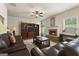 Inviting living room with a brick fireplace, plush leather seating, and built-in shelving at 1001 Hartwell Rd, Locust Grove, GA 30248