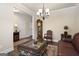 Comfortable living room featuring a grandfather clock, stylish decor, and hardwood floors at 1001 Hartwell Rd, Locust Grove, GA 30248