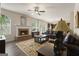 Spacious living room featuring a brick fireplace, leather sofas and an adjacent kitchen view at 1001 Hartwell Rd, Locust Grove, GA 30248