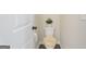 Powder room with toilet, tan rug, neutral walls and decor, and white trim at 1001 Hartwell Rd, Locust Grove, GA 30248