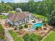 Expansive backyard featuring a pool, pergola, patio and firepit, surrounded by lush landscaping and green lawn at 1422 New Holland Cir, Mcdonough, GA 30252