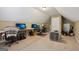Finished attic area with multiple work spaces and comfortable seating at 1422 New Holland Cir, Mcdonough, GA 30252