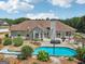Backyard featuring a pool, patio, pergola and lush landscaping, framed by a view of the house's exterior at 1422 New Holland Cir, Mcdonough, GA 30252