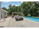 Backyard with a covered barbecue area, pool, and spacious patio at 1422 New Holland Cir, Mcdonough, GA 30252