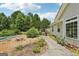 Landscaped backyard featuring a pool, grilling area and a charming walkway to the house at 1422 New Holland Cir, Mcdonough, GA 30252