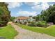 Backyard, with a pool, dining area and a gravel driveway leading towards the house at 1422 New Holland Cir, Mcdonough, GA 30252