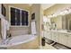Bright bathroom with a large tub, vanity with double sinks, and tiled floor at 1422 New Holland Cir, Mcdonough, GA 30252