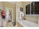 Bright bathroom with a large soaking tub and a separate toilet room at 1422 New Holland Cir, Mcdonough, GA 30252