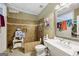 Bathroom with tile floors and walls, shower, toilet, and sink, with a large mirror at 1422 New Holland Cir, Mcdonough, GA 30252