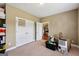 Bedroom with beige walls and carpet, showcasing ample space and storage with double closets at 1422 New Holland Cir, Mcdonough, GA 30252