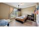 Bedroom with beige walls, carpeted floor, ceiling fan, and a bed next to the window at 1422 New Holland Cir, Mcdonough, GA 30252