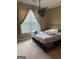 Neutral bedroom featuring mounted TV, and natural light streaming through the window at 1422 New Holland Cir, Mcdonough, GA 30252
