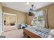 Bedroom featuring a large window, carpet, and a hanging television screen, with a view to an open doorway at 1422 New Holland Cir, Mcdonough, GA 30252